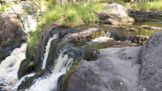 Небольшой водопад среди камней и зелени