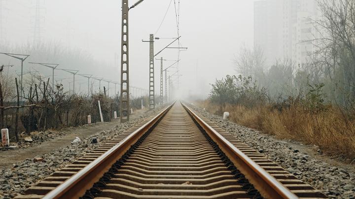 Рельсы уходят в даль на фоне неба.