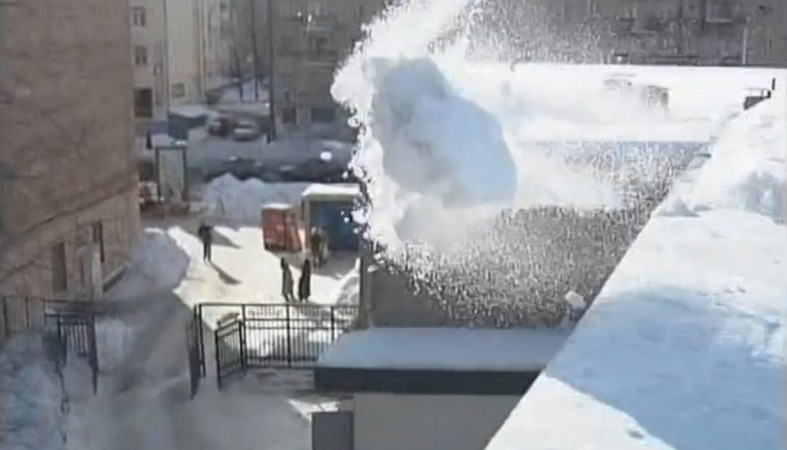 снег с крыши убирают