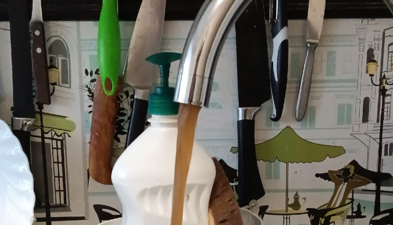 темная вода течет из крана